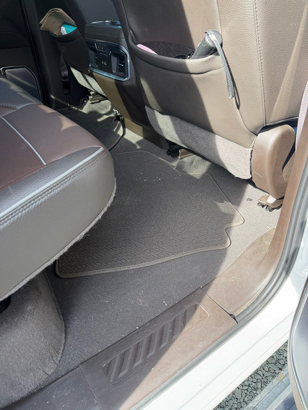 Car interior floor mat detail cleaning after a commuter vehicle service