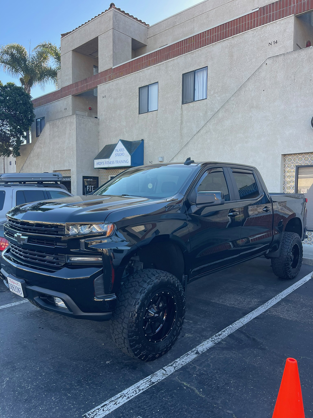 Lifted black Chevy Silverado during a paint correction detail service