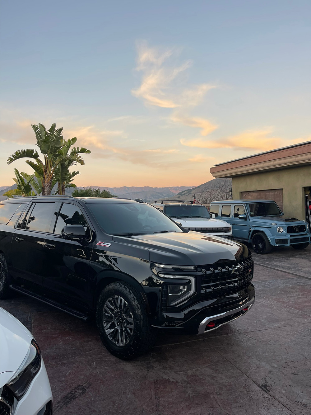 A row of freshly detailed luxury SUVs at sunset after a fleet mobile detailing appointment