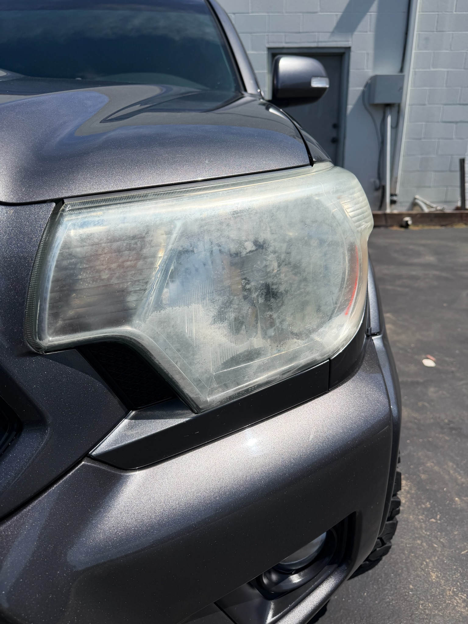 Toyota Tacoma headlight lens oxidized and yellowed before restoration