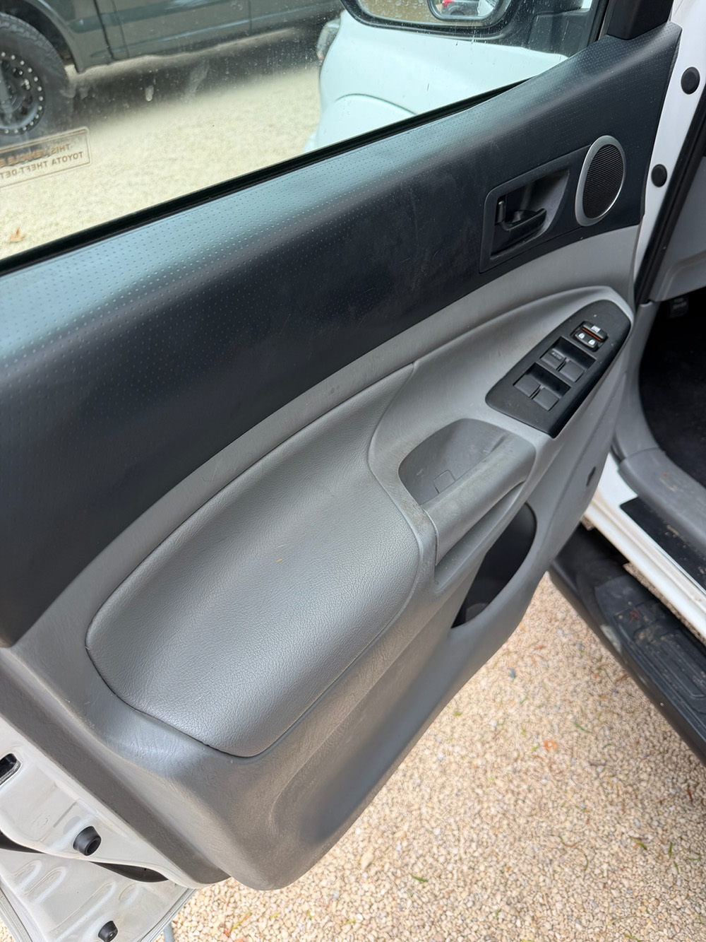 Toyota Tacoma interior door panel after a professional hand-detailing pass, the kind of work an automated wash never touches