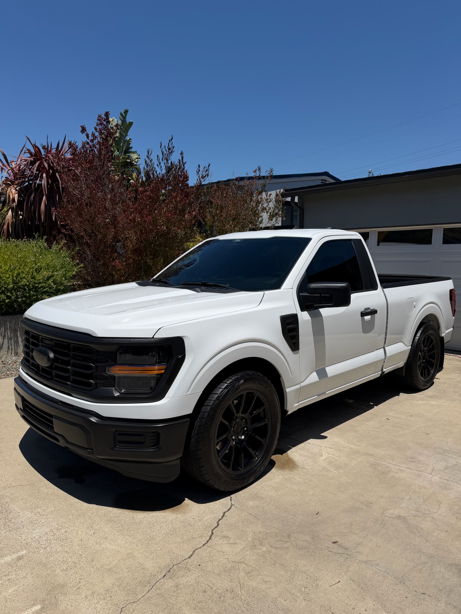 White Ford F-150 with a blacked-out ceramic coating finish on the front end