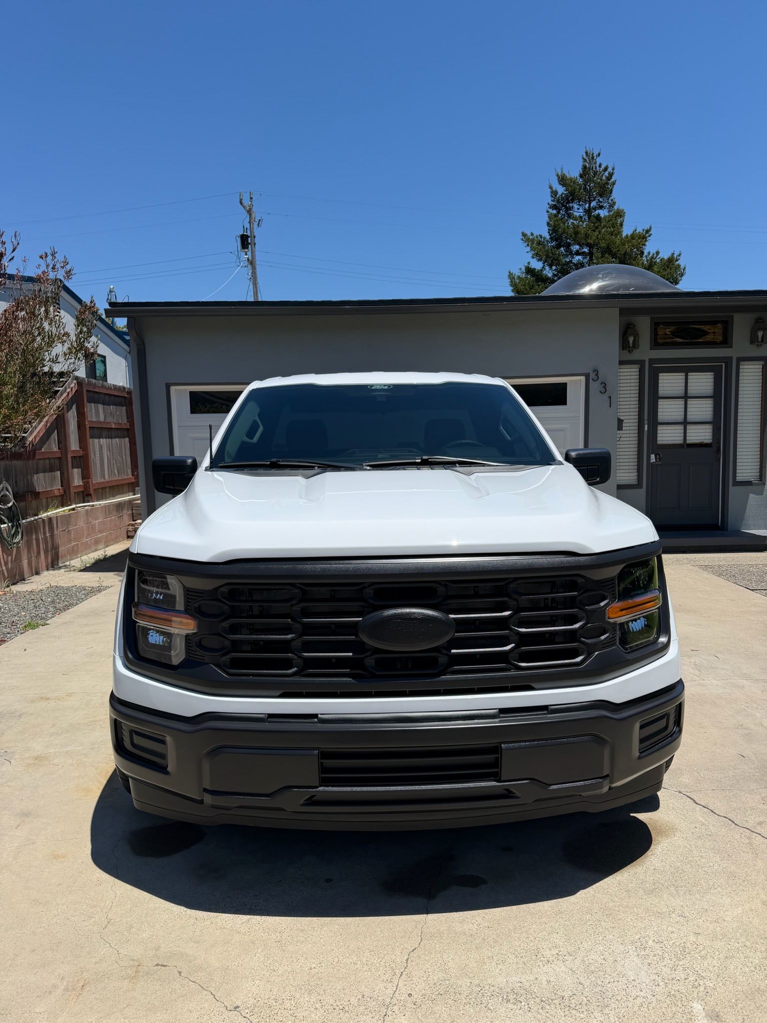 White Ford F-150 with a ceramic-coated front end, an example of the layered maintenance approach that holds gloss over time